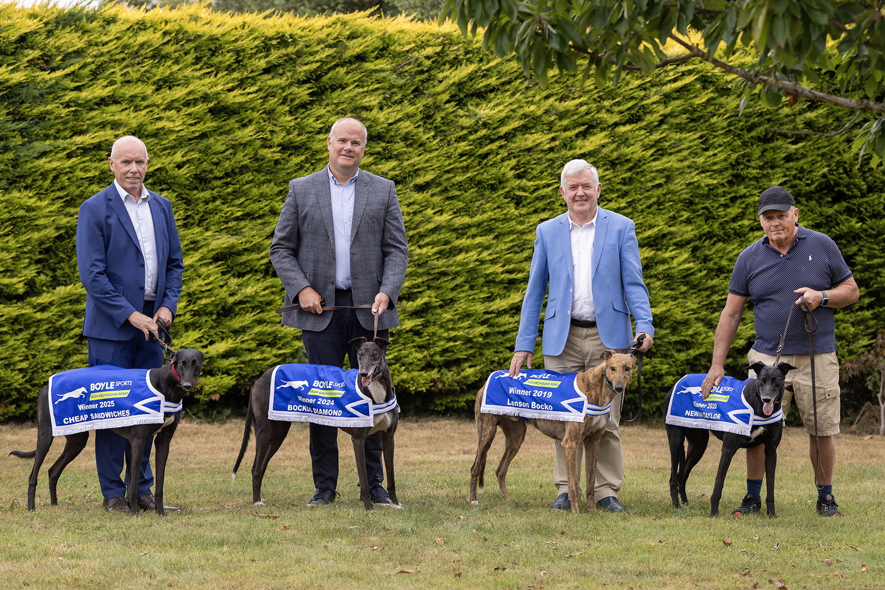 Pictured at the launch of the 2026 BOYLE Sports Irish Greyhound Derby at Riverside Kennels in Tipperary are L-R: Tim Lucey (CEO, GRI), Kieran Holden (Sponsorship Manager BOYLE Sports), Pat Flanagan (Chairman GRI) and Graham Holland (5 time Irish Greyhound Derby Winning Trainer), with 4 of his 5 Irish Greyhound Derby Champions - Lenson Bocko (2019), Newinn Taylor (2020), Bockos Diamond (2024) and Cheap Sandwiches (2025). Pictured at the launch of the 2026 BOYLE Sports Irish Greyhound Derby at Riverside Kennels in Tipperary are L-R: Tim Lucey (CEO, GRI), Kieran Holden (Sponsorship Manager BOYLE Sports), Pat Flanagan (Chairman GRI) and Graham Holland (5 time Irish Greyhound Derby Winning Trainer), with 4 of his 5 Irish Greyhound Derby Champions - Lenson Bocko (2019), Newinn Taylor (2020), Bockos Diamond (2024) and Cheap Sandwiches (2025).